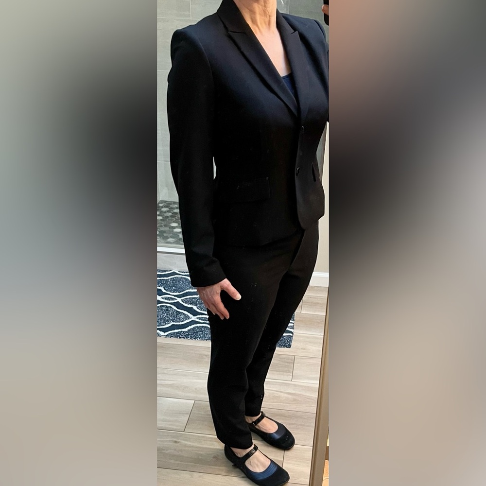 Look polished and professional in flattering Calvin Klein navy blue suit